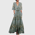 Front view of the Elodie Summer Maxi Dress Floral Print Wide Sleeve in green, featuring a wrap V-neckline, wide three-quarter sleeves, all-over floral print, and a flowing maxi silhouette. Designed by Bella Hudson.