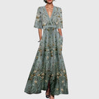Front view of the Elodie Summer Maxi Dress Floral Print Wide Sleeve in green, featuring a wrap V-neckline, wide three-quarter sleeves, all-over floral print, and a flowing maxi silhouette. Designed by Bella Hudson.