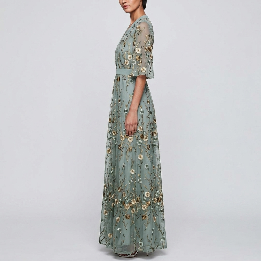 Side view of the Elodie Summer Maxi Dress Floral Print Wide Sleeve in green, showcasing the wrap-style bodice, wide flutter sleeves, floral print, and elegant flowing maxi silhouette. Designed by Bella Hudson.