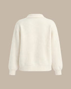 Elowen Apricot cardigan laid flat from the back, showing the collar, relaxed shape, and ribbed hem.