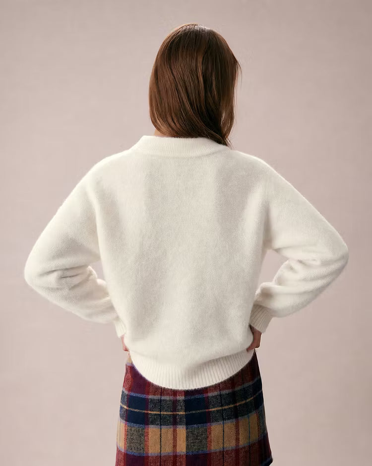 Elowen Apricot cardigan shown from the back, with a soft knit finish, ribbed hem, and relaxed sleeves.