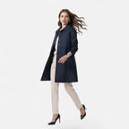 Front model view of the Emilia Trench Coat Midi Double-Breasted in navy blue, showcasing the pointed collar, double-breasted button front, long sleeves, side pockets, and structured midi-length silhouette. Designed by Bella Hudson.