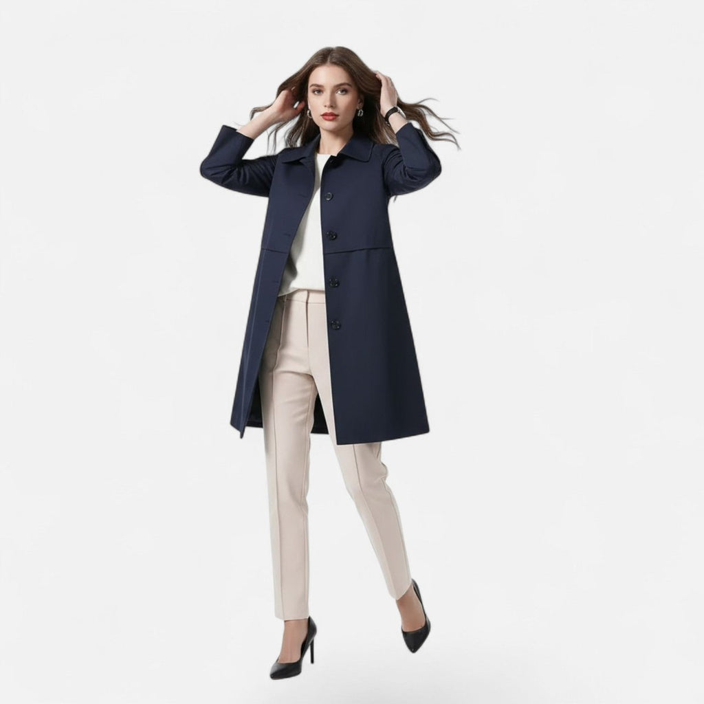 Open front view of the Emilia Trench Coat Midi Double-Breasted in navy blue, featuring a pointed collar, long sleeves, double-breasted construction, and a straight midi-length silhouette. Designed by Bella Hudson.