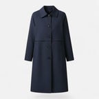 Front product view of the Emilia Trench Coat Midi Double-Breasted in navy blue, featuring a pointed collar, double-breasted button closure, long sleeves, side pockets, and a straight midi-length silhouette. Designed by Bella Hudson.