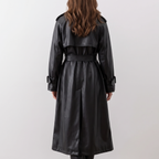 Back view of the Emma Trench Coat Faux-Leather Belted in black, featuring a tied waist belt, long sleeves, structured back construction, and knee-length silhouette. Designed by Bella Hudson.