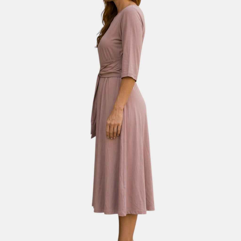Side view of the Estelle Midi Dress Cotton A-Line Tie-Waist in pink, showcasing the relaxed A-line silhouette, three-quarter sleeves, and adjustable self-tie waist. Designed by Bella Hudson.