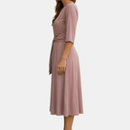 Side view of the Estelle Midi Dress Cotton A-Line Tie-Waist in pink, showcasing the relaxed A-line silhouette, three-quarter sleeves, and adjustable self-tie waist. Designed by Bella Hudson.