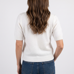 Estelle White short sleeve crewneck sweater in a close back view showing the textured knit and ribbed hem.