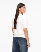 Estelle White short sleeve crewneck sweater shown from the back with ribbed cuffs and hem.