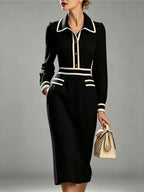 Evelyn Black long-sleeve midi dress with contrast-trimmed collar, defined waist, and decorative pocket flaps