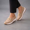Farrah Sneaker Loafers in Beige Suede with Gold Buckle shown in front view, featuring a soft suede upper, polished gold-buckle detail, slip-on loafer design, lightweight sneaker-inspired sole, cushioned footbed, and versatile everyday silhouette, designed by Bella Hudson.