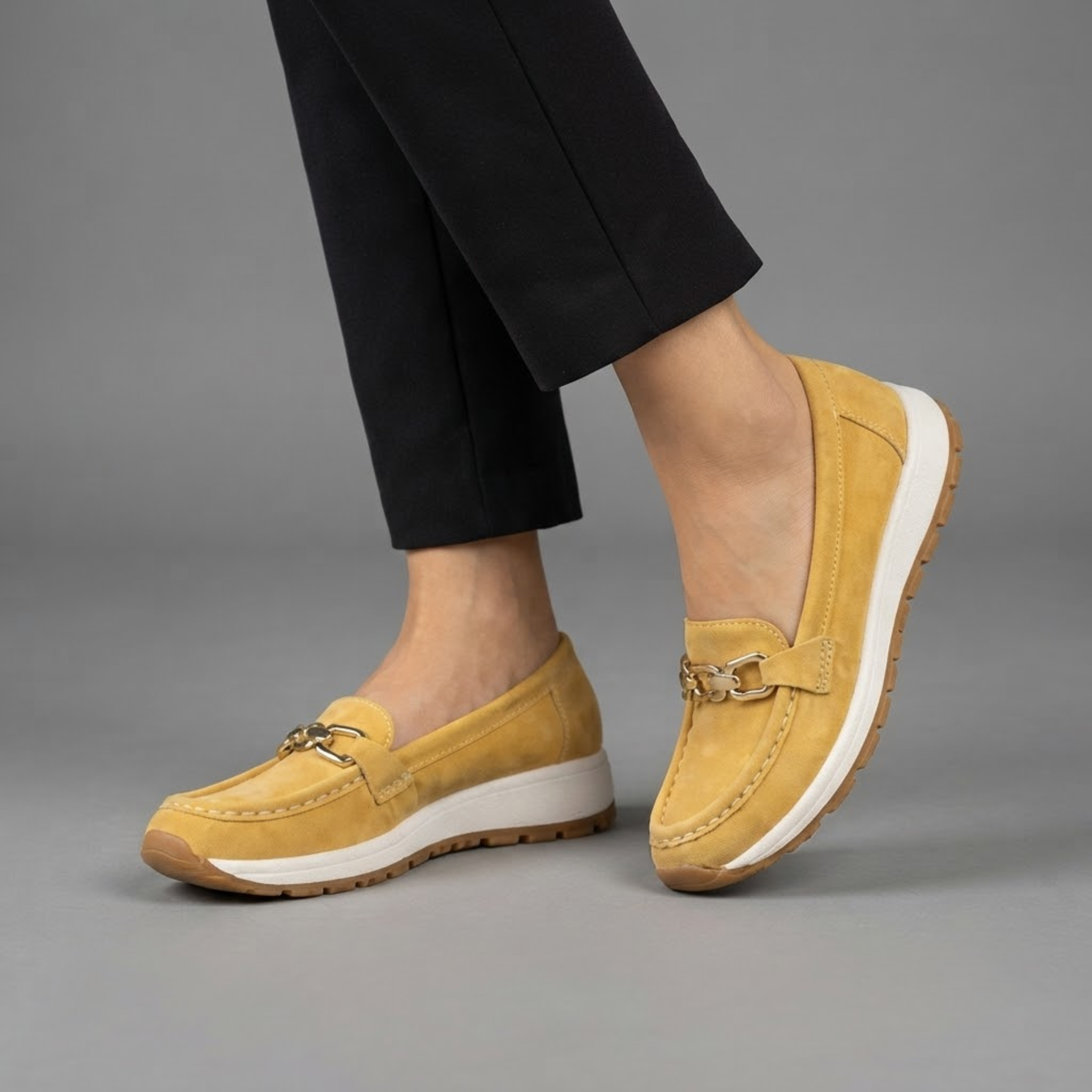 Farrah Yellow Suede Sneaker Loafers with Gold Buckle shown in front view, featuring a slip-on design, cushioned sole, and lightweight sneaker-inspired outsole.