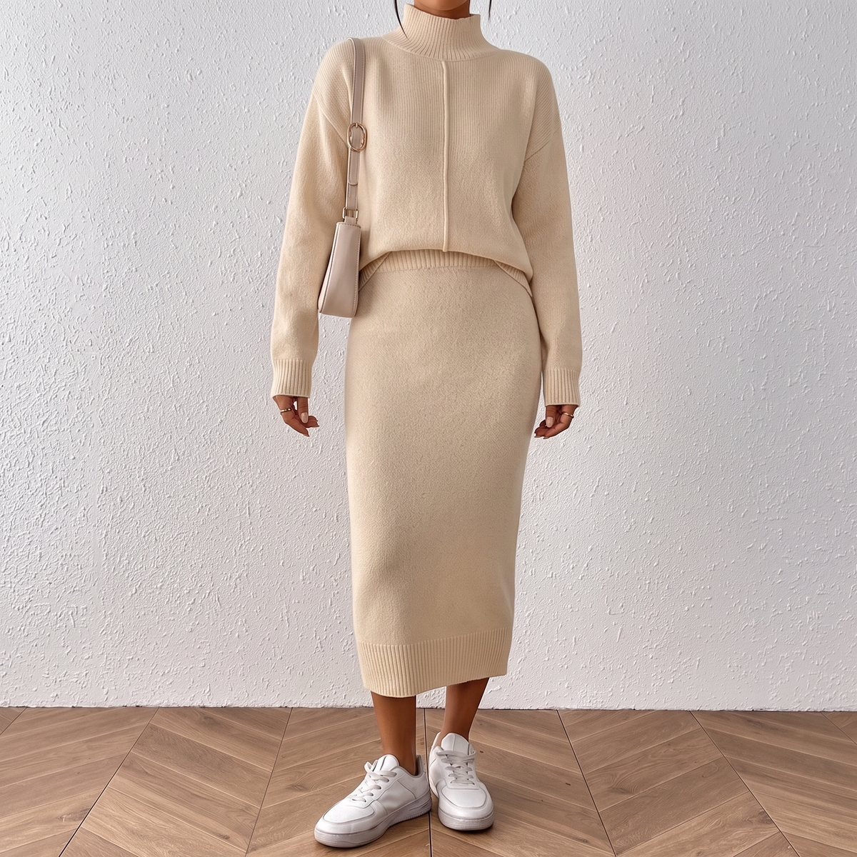 Front view of the Faustine Two-Piece Set Knitted Midi Skirt in khaki, featuring a relaxed long-sleeve knit top with a high neckline and matching straight midi skirt. Designed by Bella Hudson.