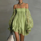 Front view of the Fenella Mini Dress Off-Shoulder Lace Puff-Sleeve Boho in green, featuring an off-the-shoulder neckline, sheer lace puff sleeves, a flowing babydoll silhouette, and delicate scalloped lace trim. Designed by Bella Hudson.