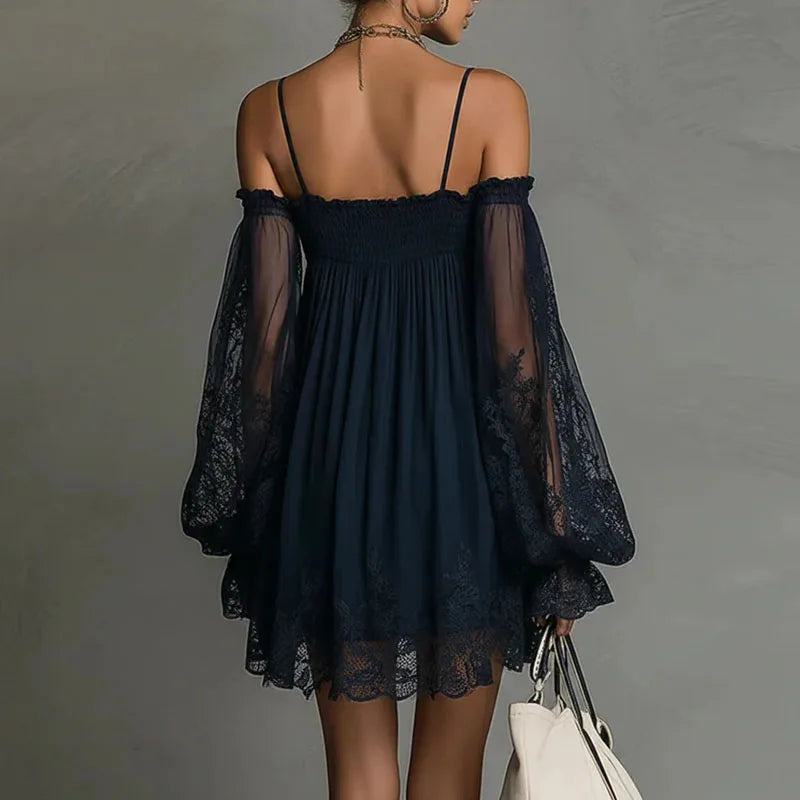 Lifestyle back view of the Fenella Mini Dress Off-Shoulder Lace Puff-Sleeve Boho in navy blue, showcasing the airy babydoll silhouette, sheer lace puff sleeves, and scalloped lace hem. Designed by Bella Hudson.