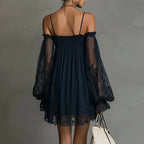 Lifestyle back view of the Fenella Mini Dress Off-Shoulder Lace Puff-Sleeve Boho in navy blue, showcasing the airy babydoll silhouette, sheer lace puff sleeves, and scalloped lace hem. Designed by Bella Hudson.
