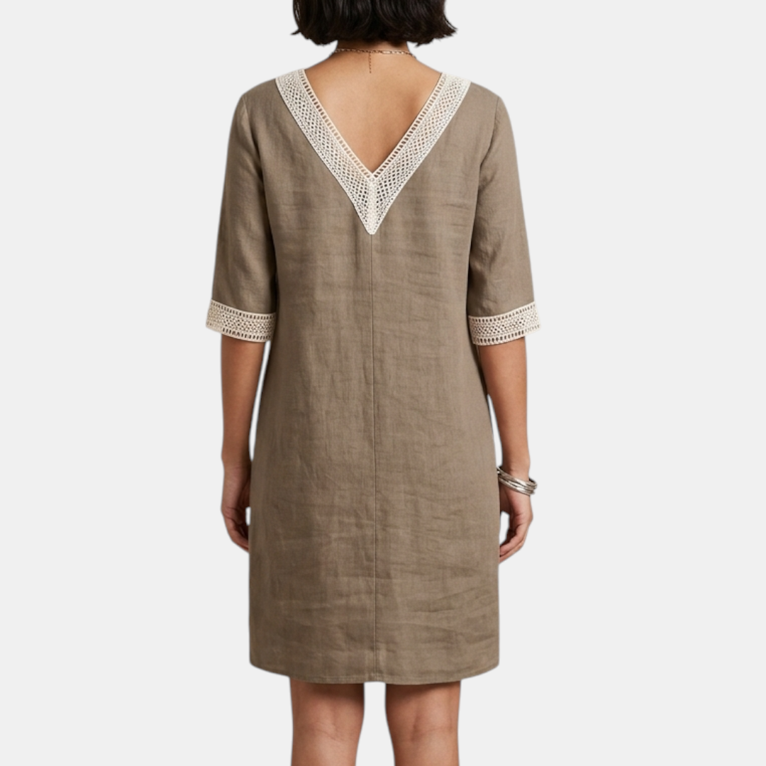 Back view of the Fenna Shift Dress Cotton Crochet-Trim V-Neck in khaki, highlighting the clean back design, relaxed shift silhouette, and rolled sleeve cuffs. Designed by Bella Hudson.