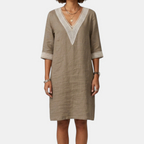 Front view of the Fenna Shift Dress Cotton Crochet-Trim V-Neck in khaki, featuring a crochet-trim V-neckline, three-quarter sleeves with rolled cuffs, side pockets, and a relaxed shift silhouette. Designed by Bella Hudson.