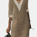 Front detail view of the Fenna Shift Dress Cotton Crochet-Trim V-Neck in khaki, showcasing the crochet-trim neckline, rolled sleeves, practical side pockets, and relaxed everyday silhouette. Designed by Bella Hudson.