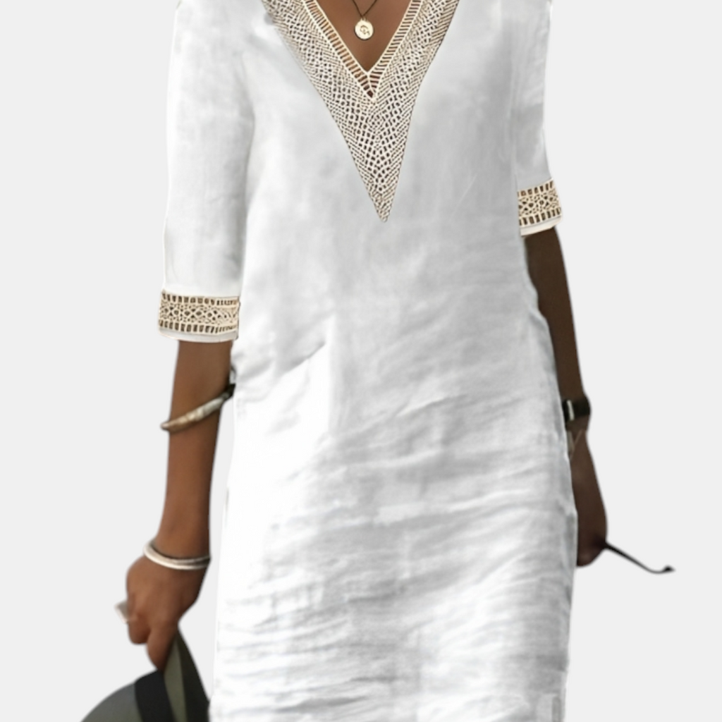 Front view of the Fenna Shift Dress Cotton Crochet-Trim V-Neck in white, featuring a crochet-trim V-neckline, rolled three-quarter sleeves, side pockets, and a relaxed shift silhouette. Designed by Bella Hudson.