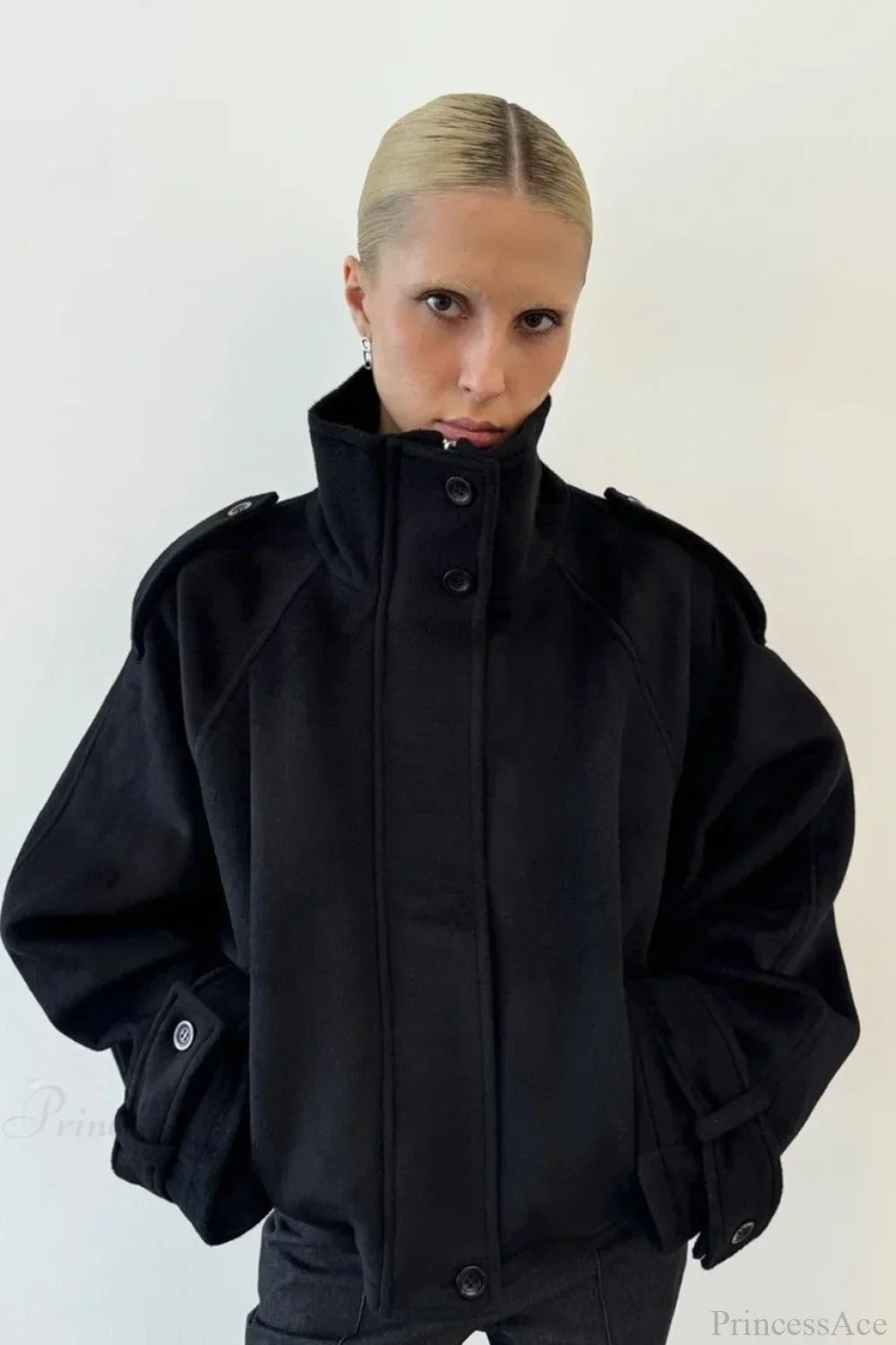 Fiona Black cropped stand-collar jacket shown from the front with buttoned collar, shoulder tabs and cuff tabs.
