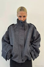 Fiona Gray cropped stand-collar jacket shown from the front with button closure, shoulder tabs and cuff straps.