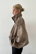 Fiona Khaki cropped jacket shown from the side with a shoulder tab and relaxed voluminous sleeve.