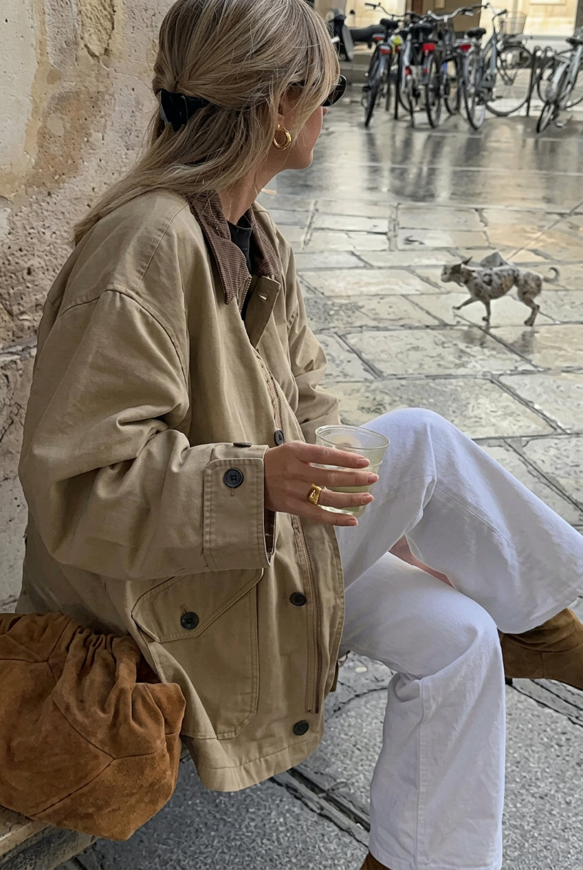 Fiona Khaki oversized utility bomber jacket in a seated side view highlighting the relaxed shape and pocket detailing