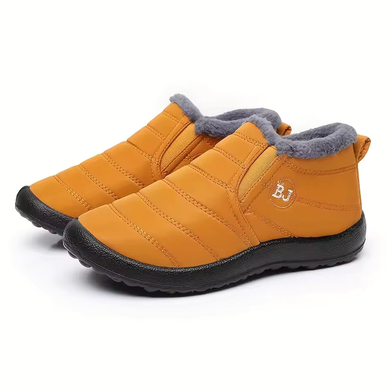 Freya orange ankle boots with quilted upper, plush faux-fur lining, rounded toe, slip-on design, and thick textured sole