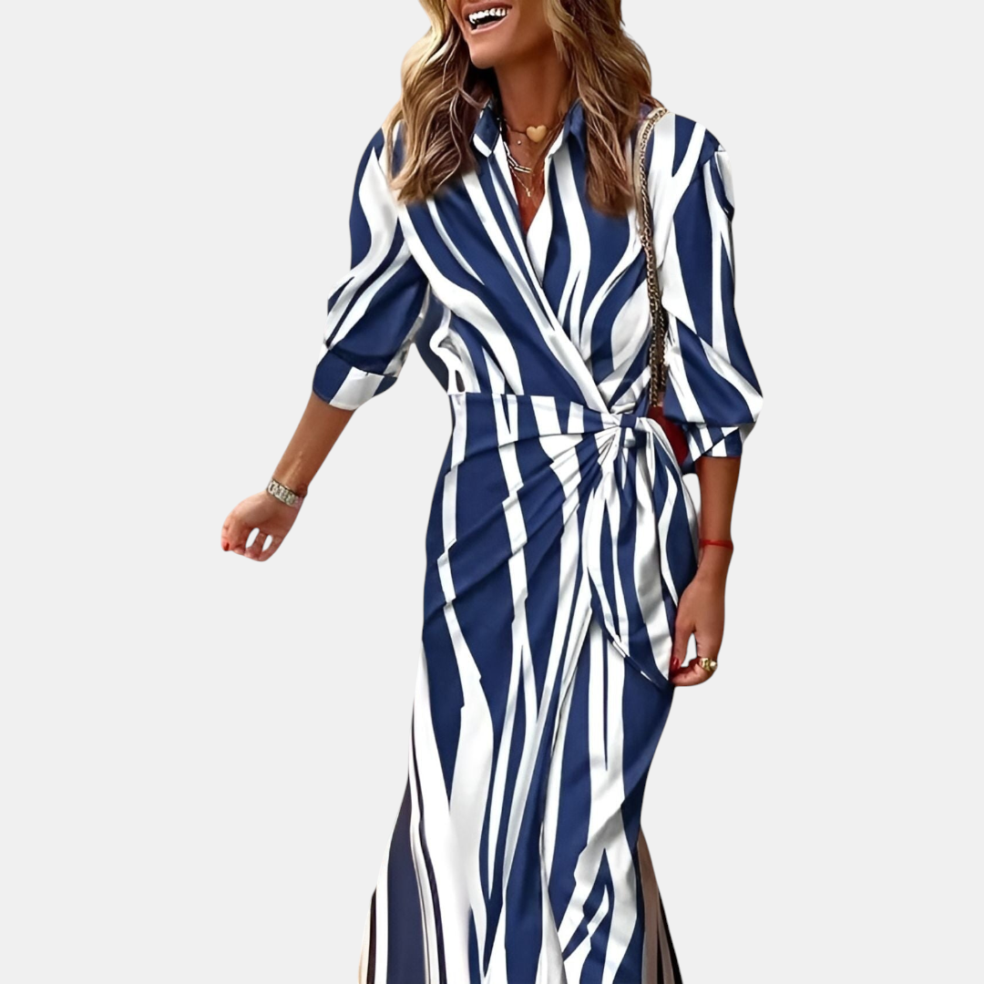 Front view of the Freya Summer Midi Dress Striped Wrap in blue, featuring a collared neckline, long sleeves, wrap-style waist, and an elegant striped midi silhouette. Designed by Bella Hudson.
