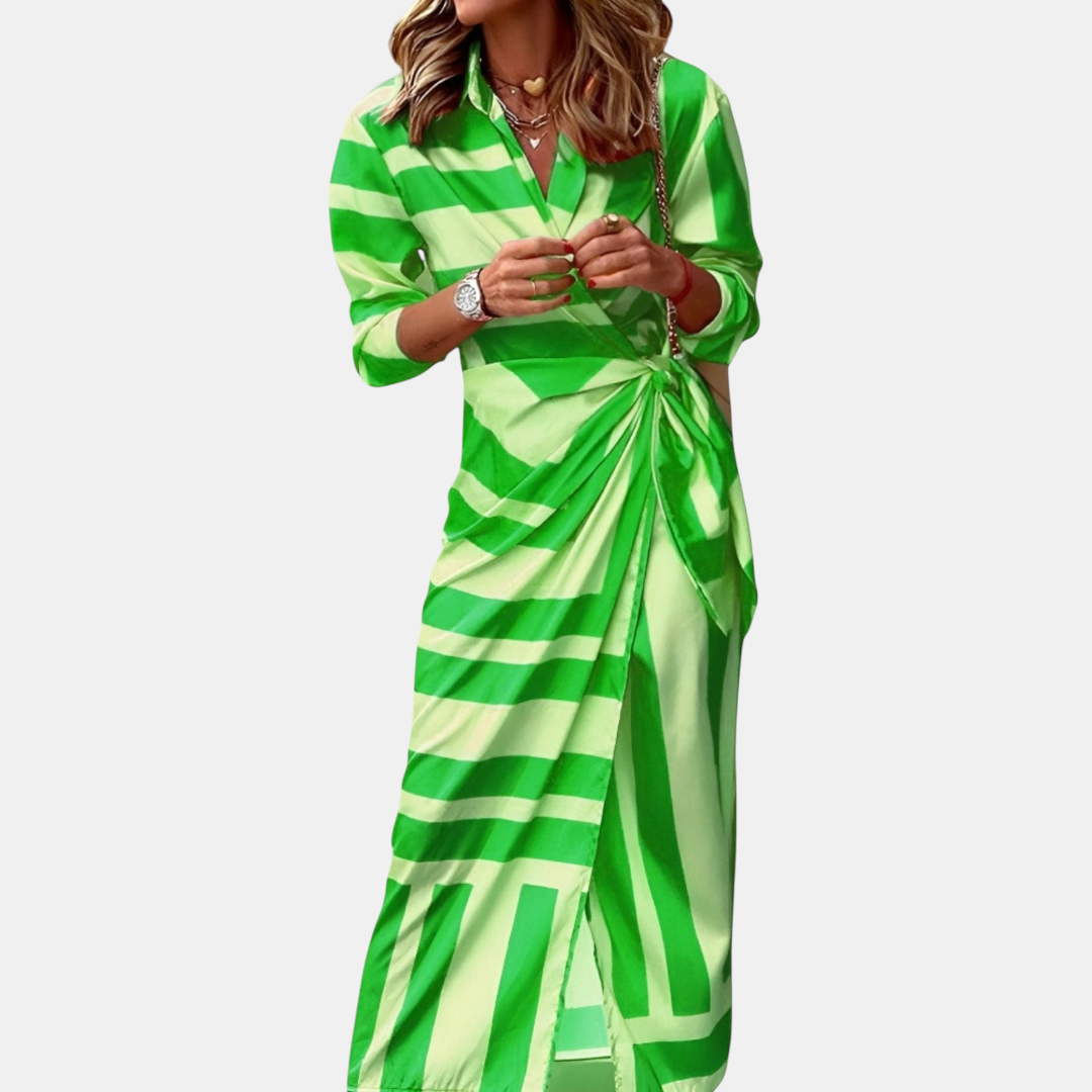 Front view of the Freya Summer Midi Dress Striped Wrap in green, featuring a collared neckline, long sleeves, wrap waist tie, and bold striped pattern. Designed by Bella Hudson.