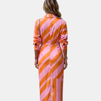 Back view of the Freya Summer Midi Dress Striped Wrap in orange, highlighting the striped pattern, relaxed long sleeves, and flowing midi-length silhouette. Designed by Bella Hudson.
