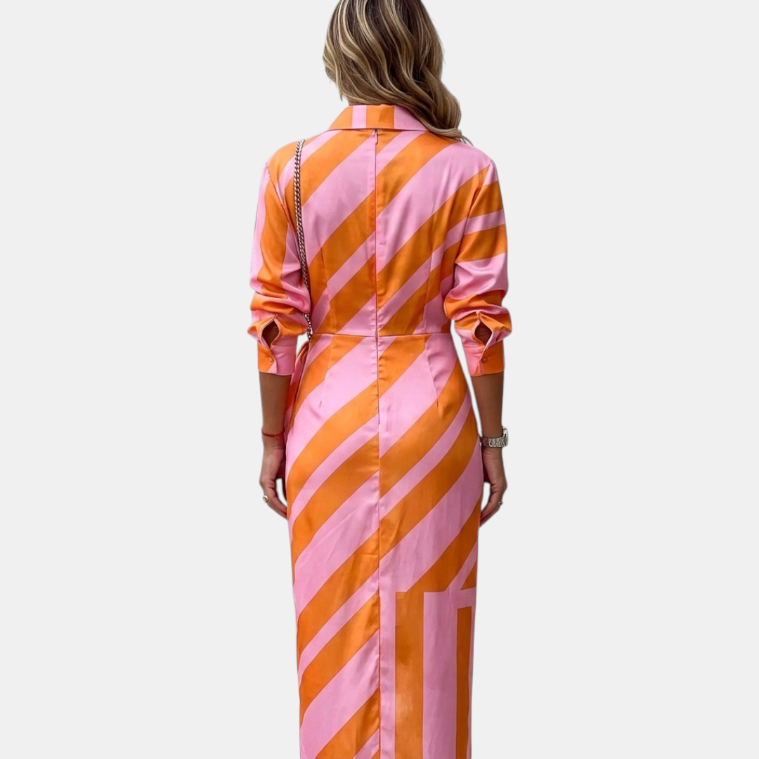 Back view of the Freya Summer Midi Dress Striped Wrap in orange, highlighting the striped pattern, relaxed long sleeves, and flowing midi-length silhouette. Designed by Bella Hudson.