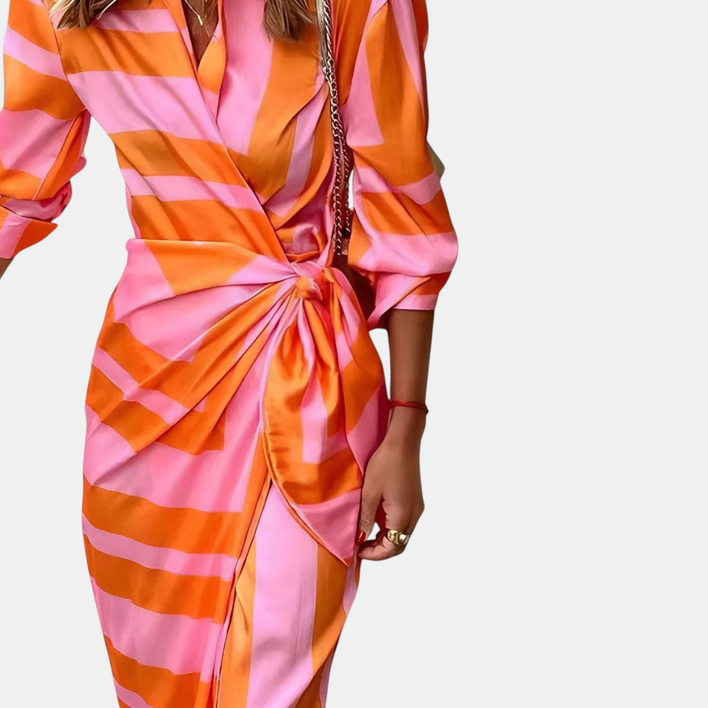 Detail of the Freya Summer Midi Dress Striped Wrap in orange, featuring the wrap waist tie, collared neckline, button-front design, and bold striped print. Designed by Bella Hudson.