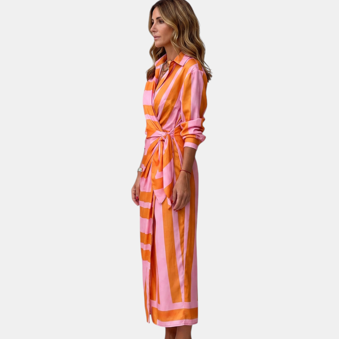 Side view of the Freya Summer Midi Dress Striped Wrap in orange, showcasing the wrap waist tie, collared neckline, long sleeves, and elegant midi-length profile. Designed by Bella Hudson.