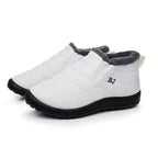 Freya white ankle boots with quilted upper, plush faux-fur lining, rounded toe, slip-on design, and thick textured sole