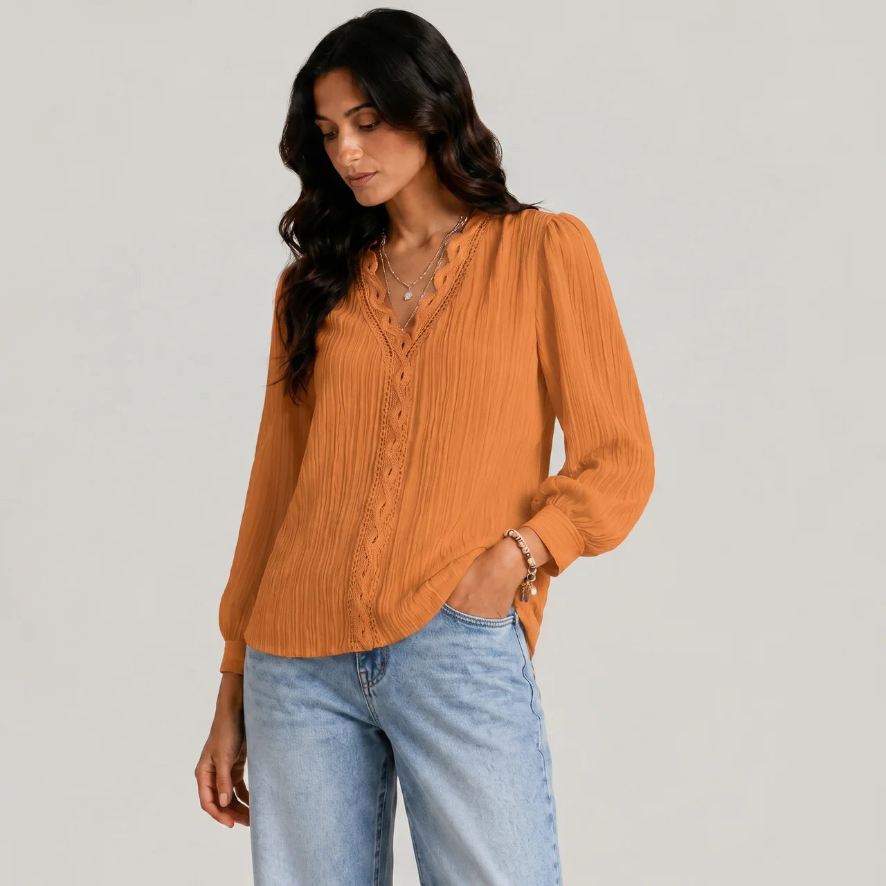 Side view of gold boho button blouse with long sleeves and textured fabric by BELLA HUDSON
