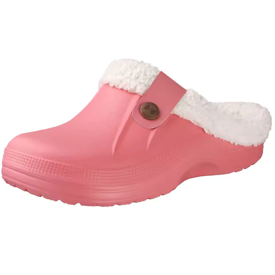 Grace Pink plush-lined clog slippers featuring a closed toe, decorative side button, open back, and thick sole