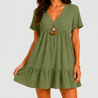 Front view of olive green tiered mini dress with V-neckline and short sleeves by BELLA HUDSON