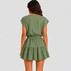 Back view of green tiered romper with drawstring waist and cap sleeves by BELLA HUDSON