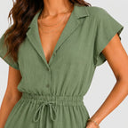 Close-up view of green tiered romper with drawstring waist and cap sleeves by BELLA HUDSON