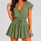 Front view of green tiered romper with drawstring waist and cap sleeves by BELLA HUDSON