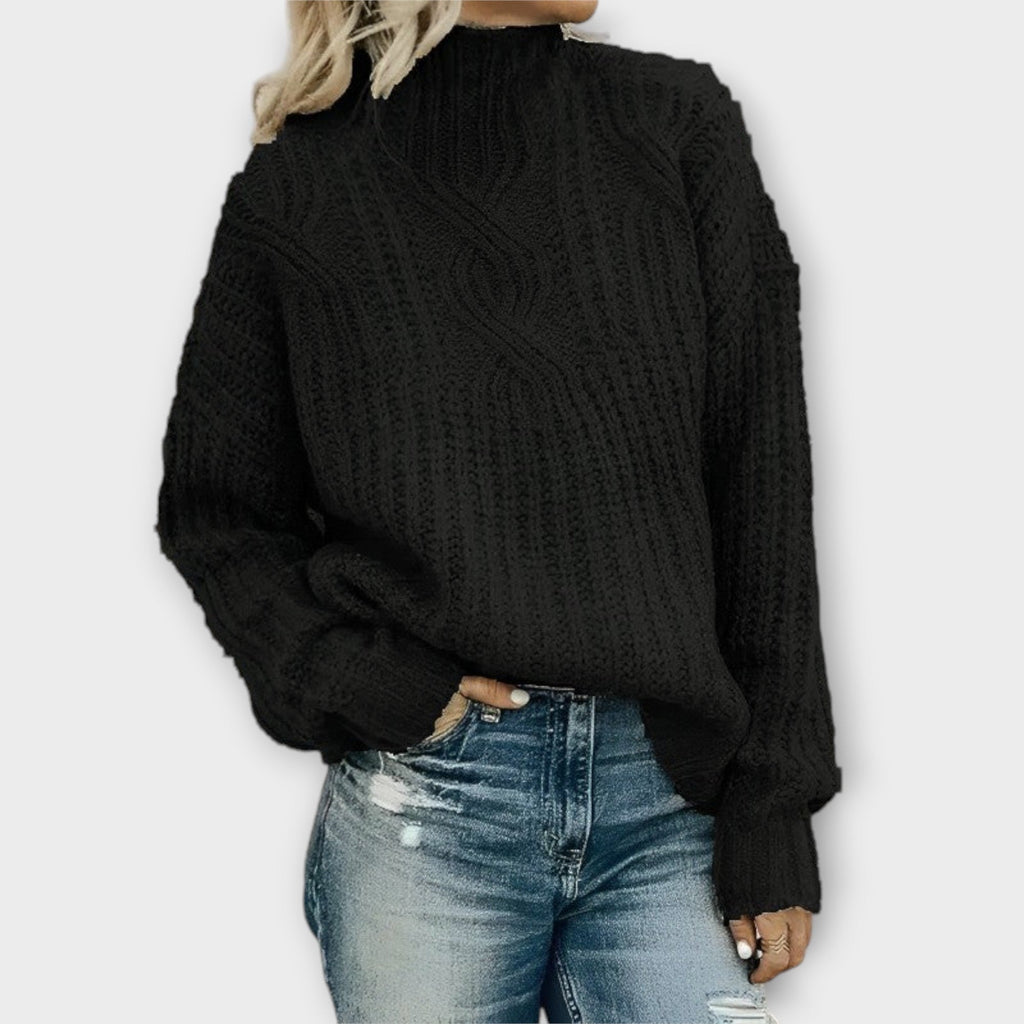Front view of the Halvard Sweater Cable-Knit Turtleneck in black, featuring a high turtleneck, textured cable-knit pattern, long sleeves, and a relaxed cozy silhouette. Designed by Bella Hudson.