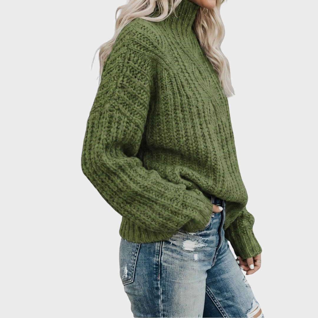 Side view of the Halvard Sweater Cable-Knit Turtleneck in green, showcasing the high turtleneck, chunky cable-knit texture, long sleeves, and relaxed fit. Designed by Bella Hudson.