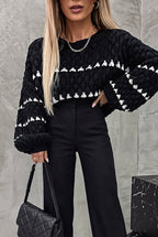 Harper Black chunky knit sweater with white stripes and balloon sleeves, styled with black trousers.