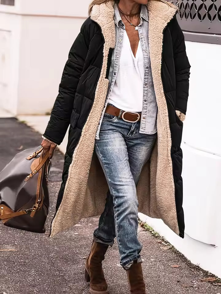 Harper Black long puffer coat featuring an oversized fleece-lined hood, quilted exterior, front closure, and long sleeves