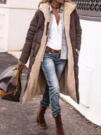 Harper Brown long puffer coat featuring a plush fleece-lined hood, quilted exterior, front zipper, and relaxed silhouette