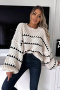 Harper Off White chunky knit sweater with black stripes and balloon sleeves, styled with dark jeans.