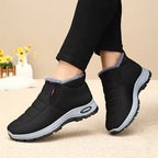 Hazel Black quilted ankle snow boots with fleece lining, side zipper, and textured outsole, shown on feet