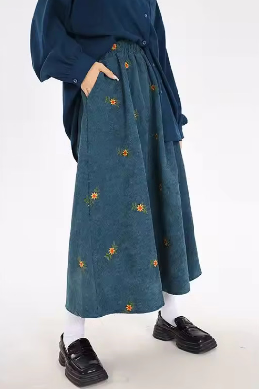 Hazel Green corduroy midi skirt with floral embroidery and flowing A-line shape
